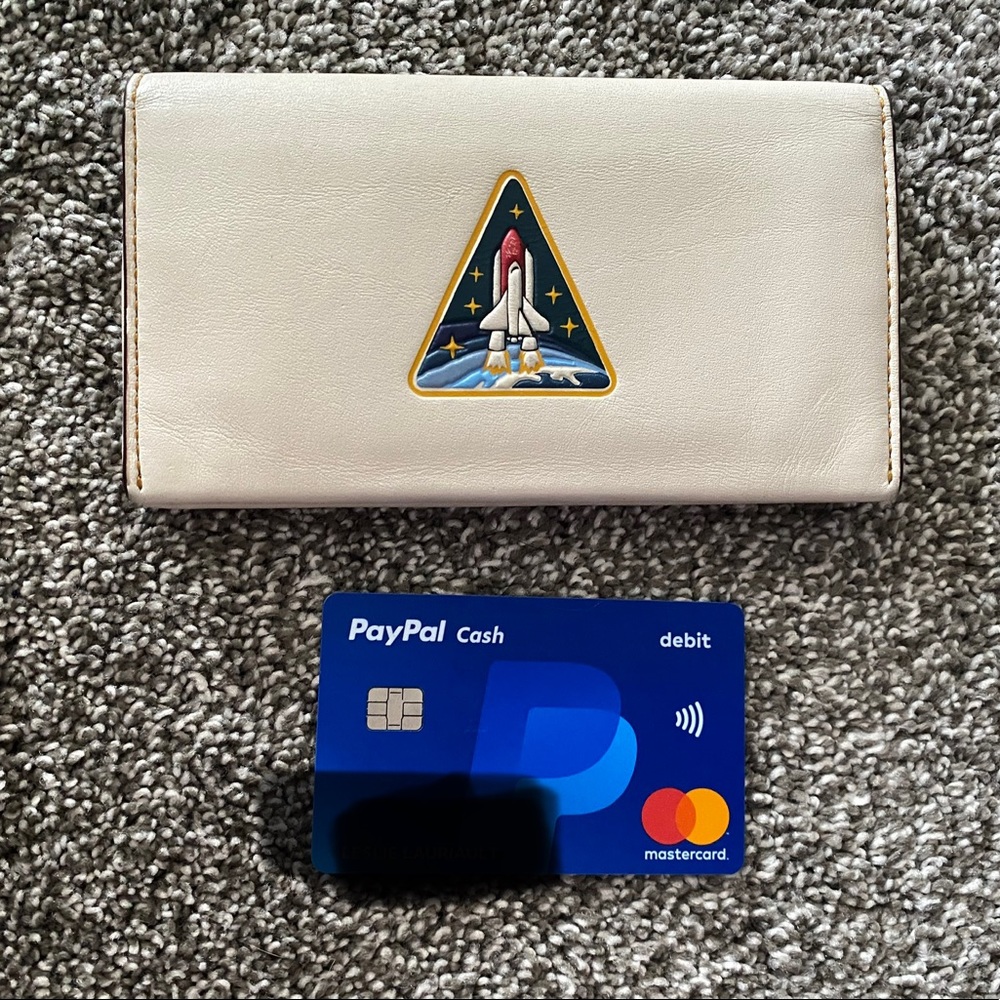 Gently used Coach x NASA Glovetanned Leather Phone Wallet “Shuttle Take Off.”